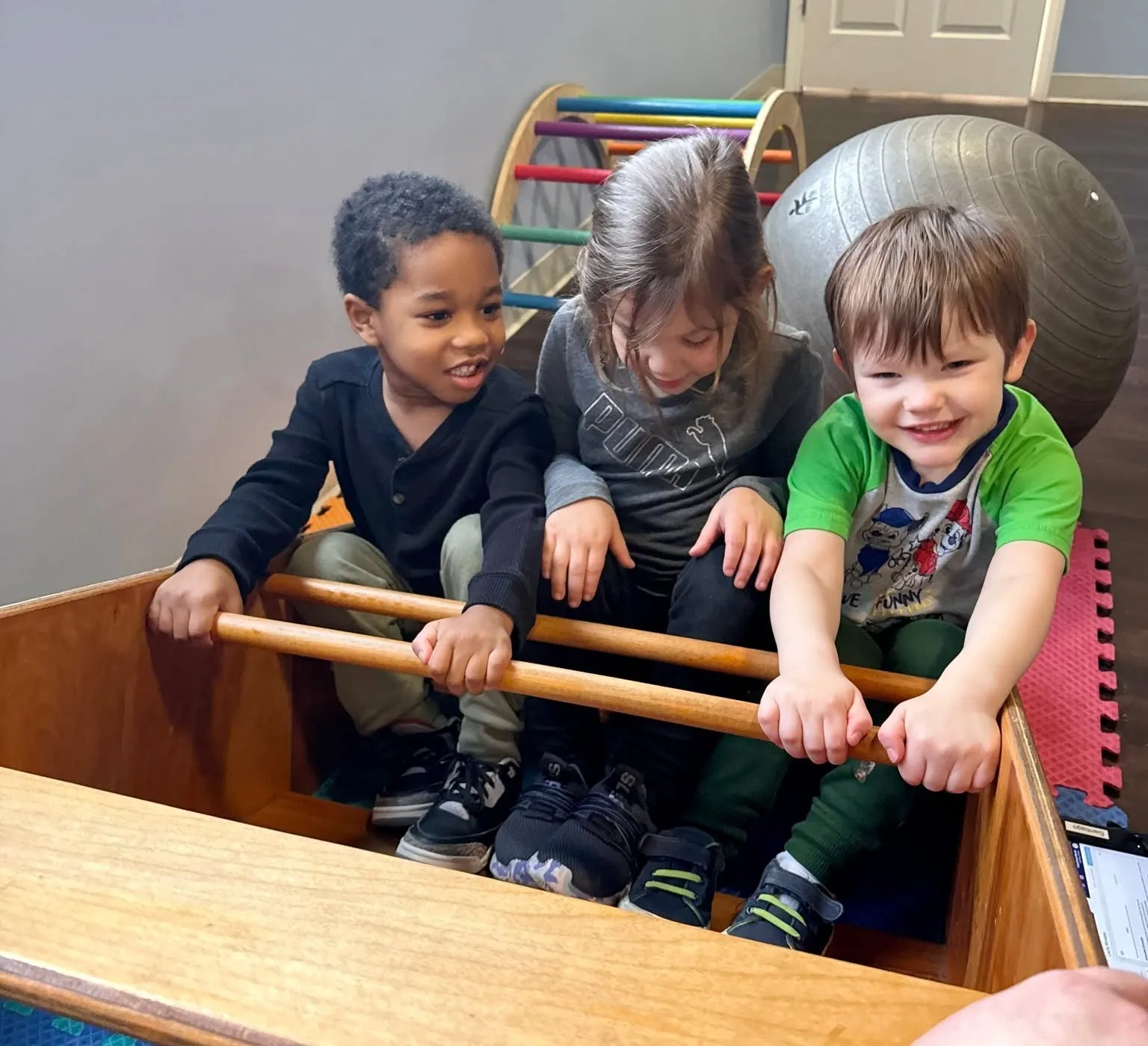 Three children playing an instrument together