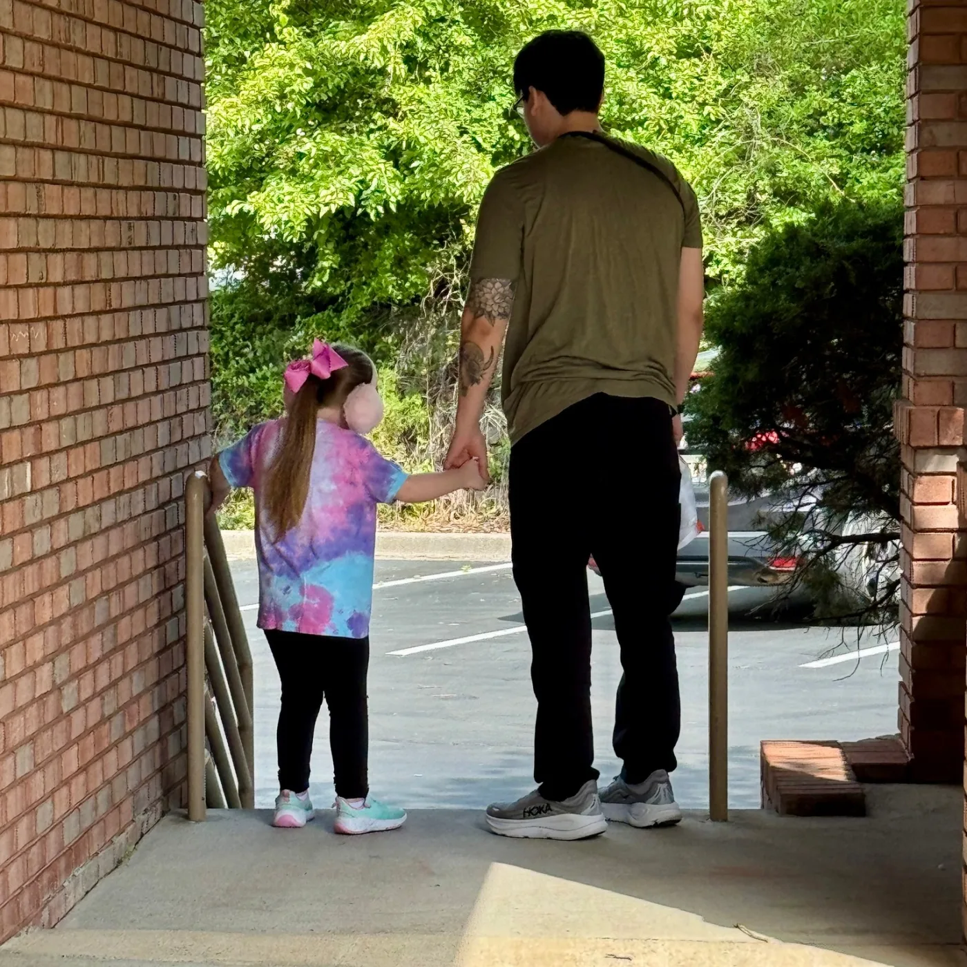 A child and therapist walking outside together